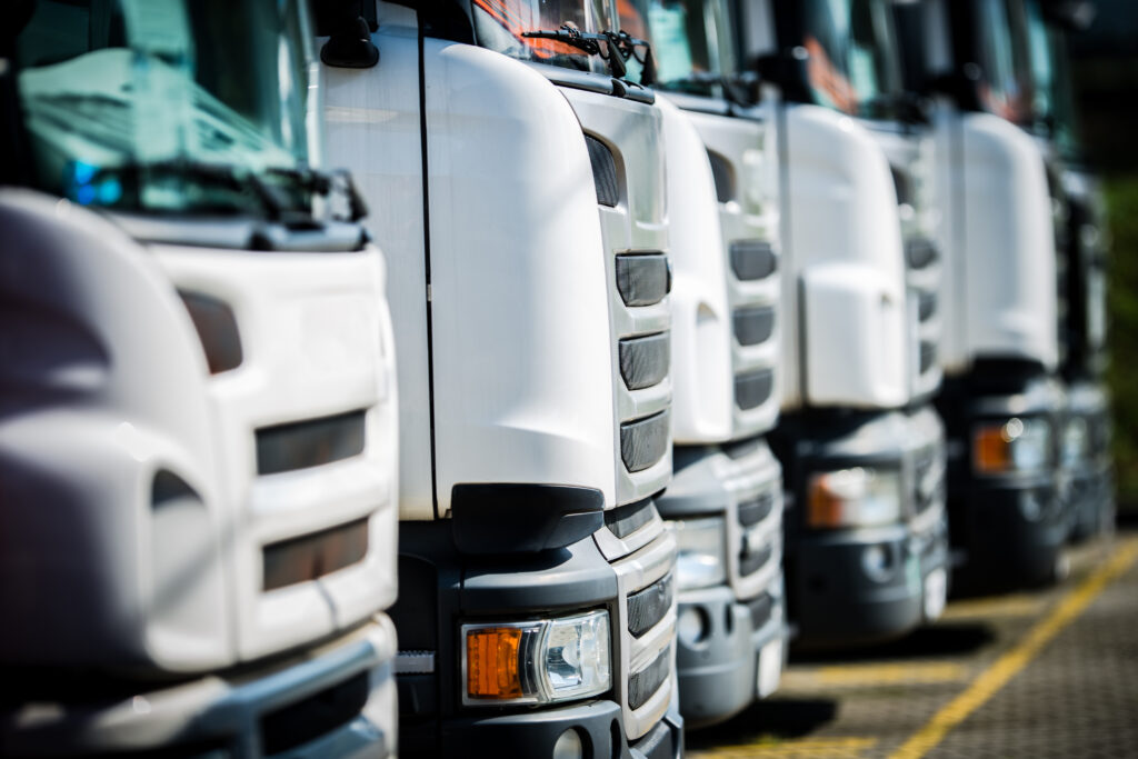trucks lined up in a storage yard during daytime